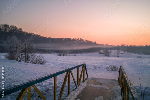 Fototapeta Naklejka Na Ścianę i Meble -  Winter sunset on the frozen lake in park