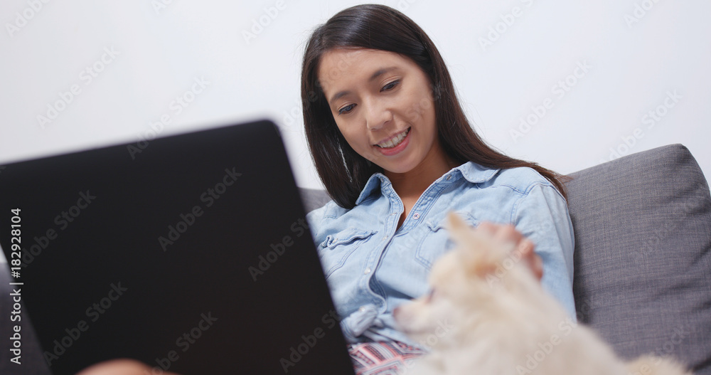 Woman use of laptop computer with her dog Woman use of laptop computer with her dog