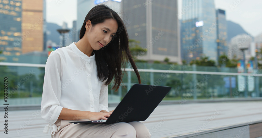 Young business woman work on laptop computer at outdoor Young business woman work on laptop computer at outdoor