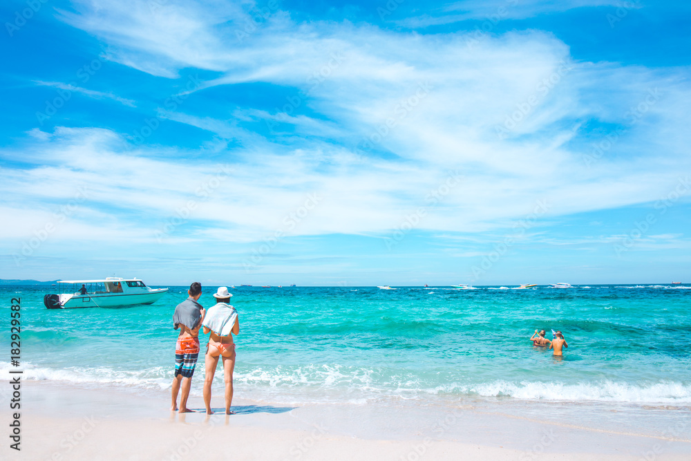 Lovers of tourists are enjoying at the sea and the clear sky at Koh Larn Island, Pattaya, Thailand.
