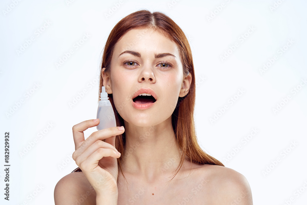 Young beautiful woman holds a drop on white isolated background, portrait Young beautiful woman holds a drop on white isolated background, portrait