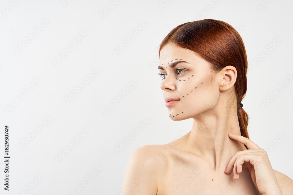 Young beautiful woman on white background with outline on face, plastic surgery, portrait Young beautiful woman on white background with outline on face, plastic surgery, portrait