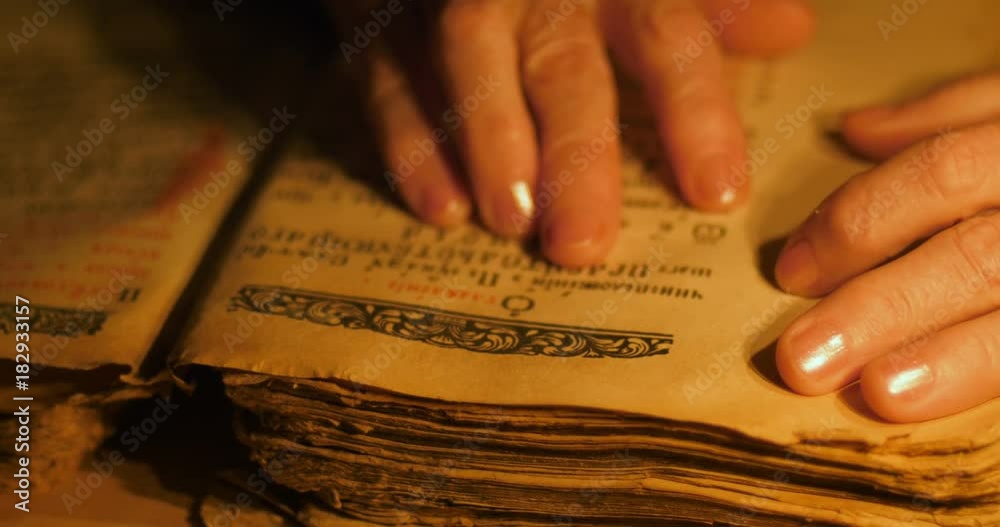 custom made wallpaper toronto digitalElderly woman reading old book by candlelight

