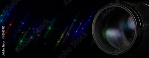 Photo lens with glittering stars flash over black background