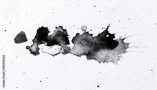 abstract black splashes on white watercolor paper. monochrome image.