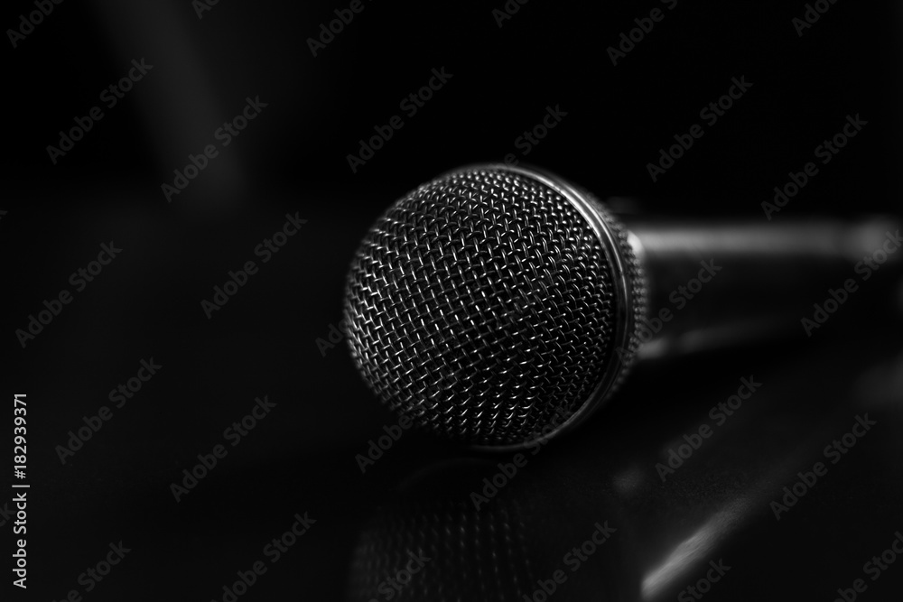 black-and-white photo of the microphone on a glossy surface black-and-white photo of the microphone on a glossy surface