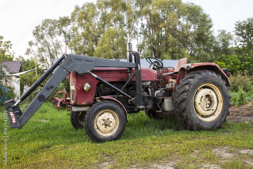 farm tractor, stands in the yard, old machine farm tractor, stands in the yard, old machine