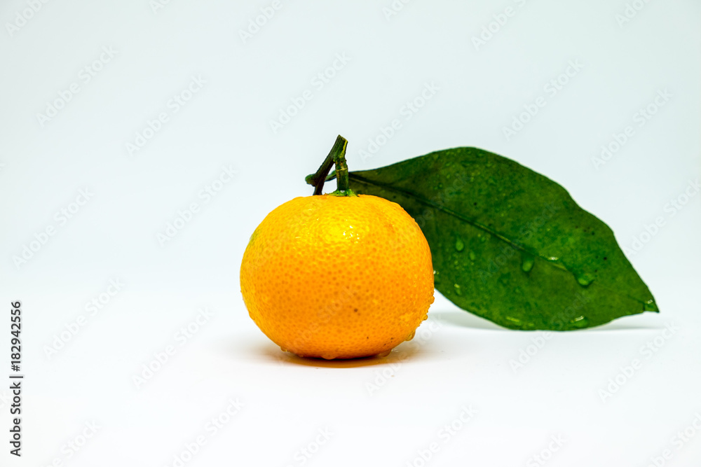 mandarin with a green leaf with water drops mandarin with a green leaf with water drops