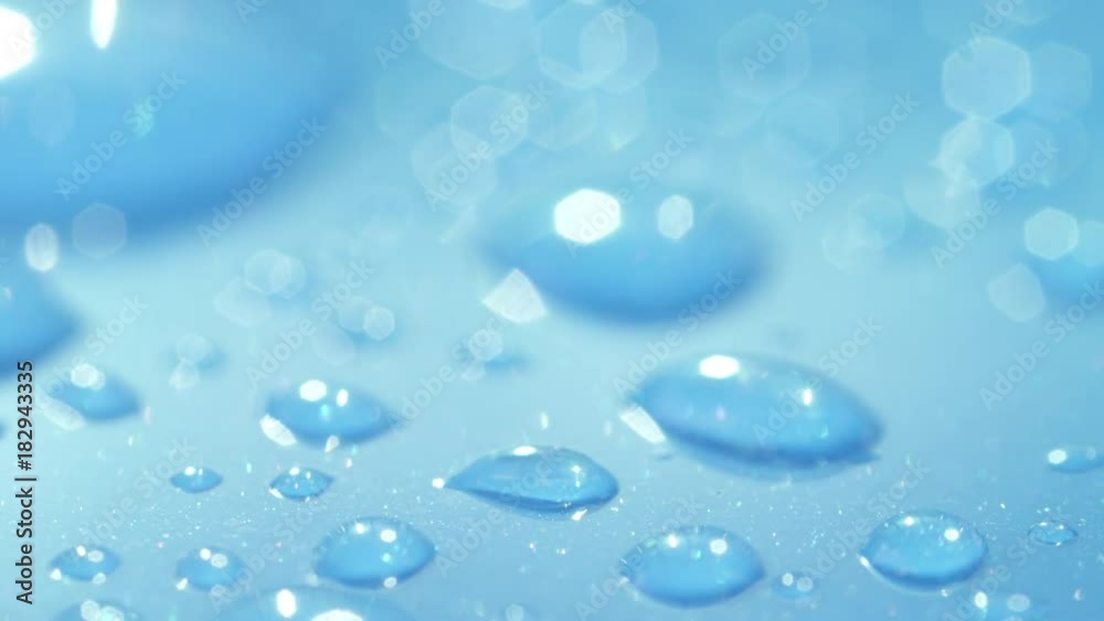DOF, MACRO, CLOSE UP: Different water droplets sparkling on the surface of a wet light blue car's roof. Reflecting waterdrops on blue surface. Shiny liquid bubbles on wet car roof after light rainfall DOF, MACRO, CLOSE UP: Different water droplets sparkling on the surface of a wet light blue car's roof. Reflecting waterdrops on blue surface. Shiny liquid bubbles on wet car roof after light rainfall