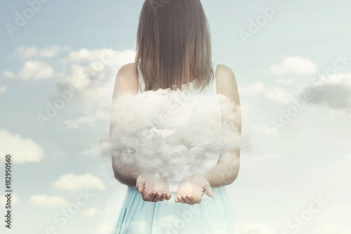 woman resembling an angel guards a small cloud in her hands