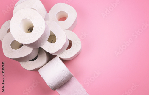 A few rolls of toilet paper on a bright colored background.