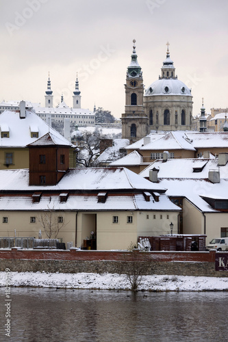 Christmas snowy Prague Lesser Town with St. Nicholas' Cathedral, Czech republic