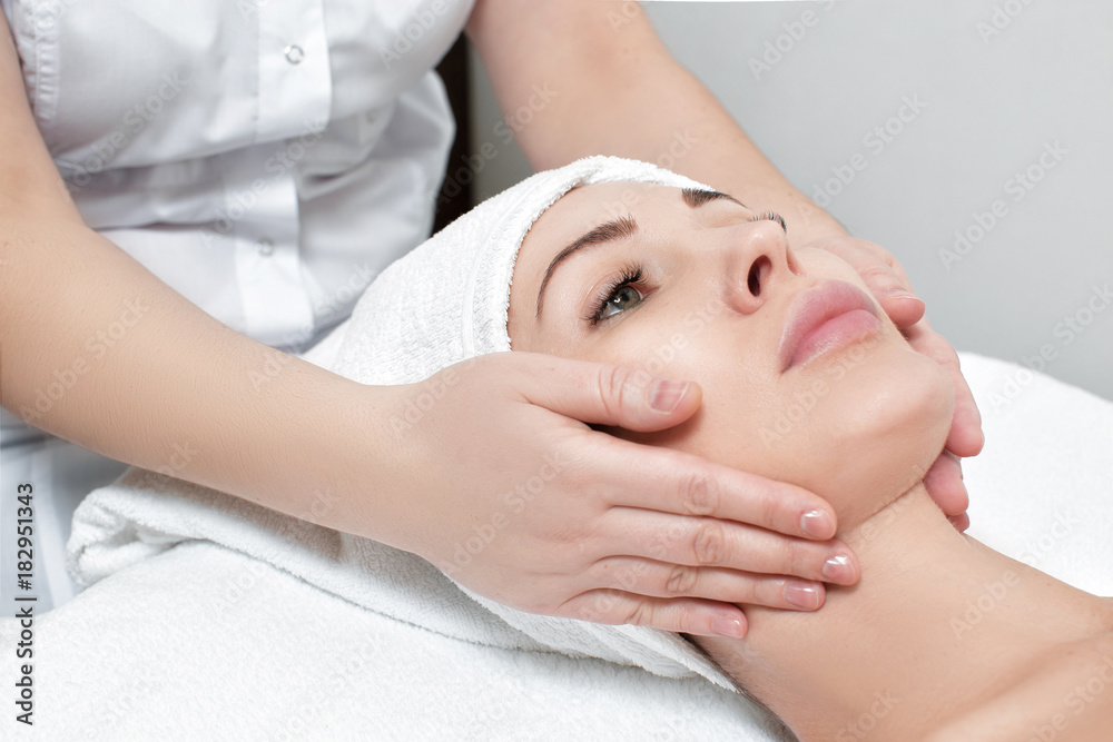 woman receiving facial massage at spa salon woman receiving facial massage at spa salon