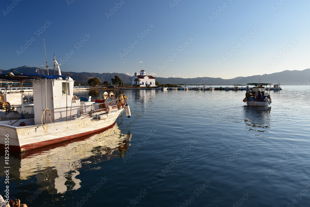 Peaceful morning on Elafonisos Island, Greece. The port of Elafonisos with view to Saint Spyridon church built on a small islet