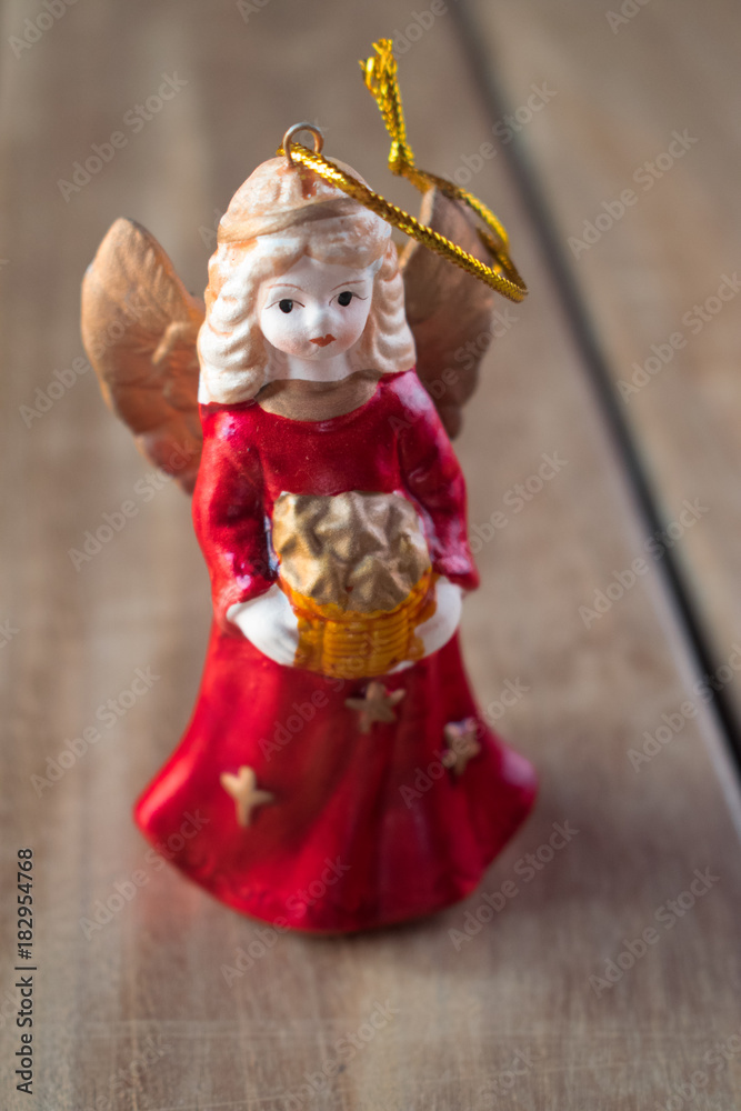 Fototapeta premium Angel with gift on wood texture