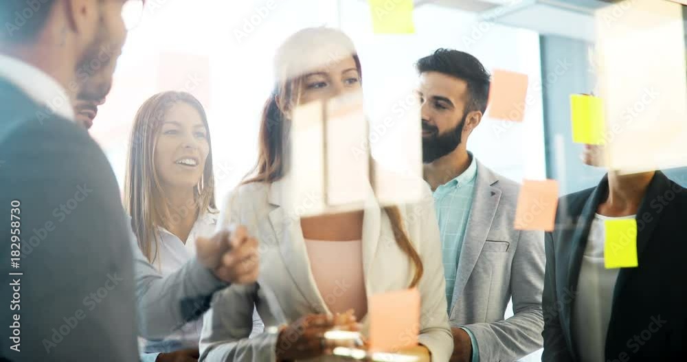 Picture of designers sticking notes in office Picture of designers sticking notes in office