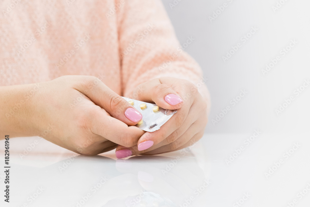 Woman hand holding contraceptive pill or birth control pill Woman hand holding contraceptive pill or birth control pill
