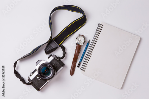 Retro camera and note on white background.