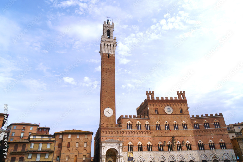 Siena city central square with old medieval tower.