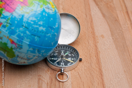 World Glode and a Navigation Compass on the wooden board. photo