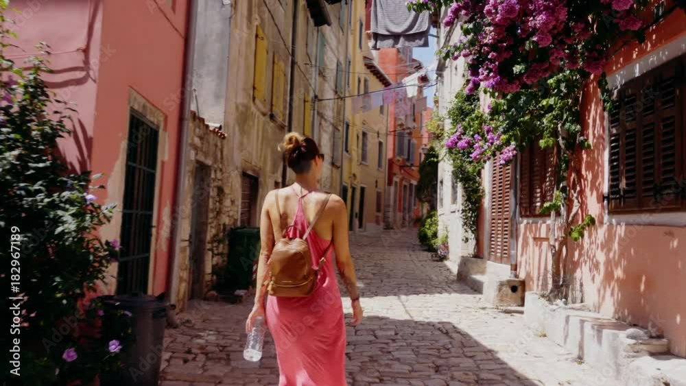 Woman walking narrow streets of a Rovinj, Croatia
