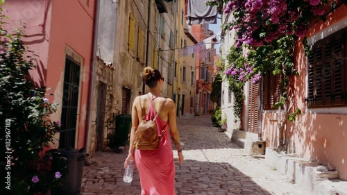 Woman walking narrow streets of a Rovinj, Croatia