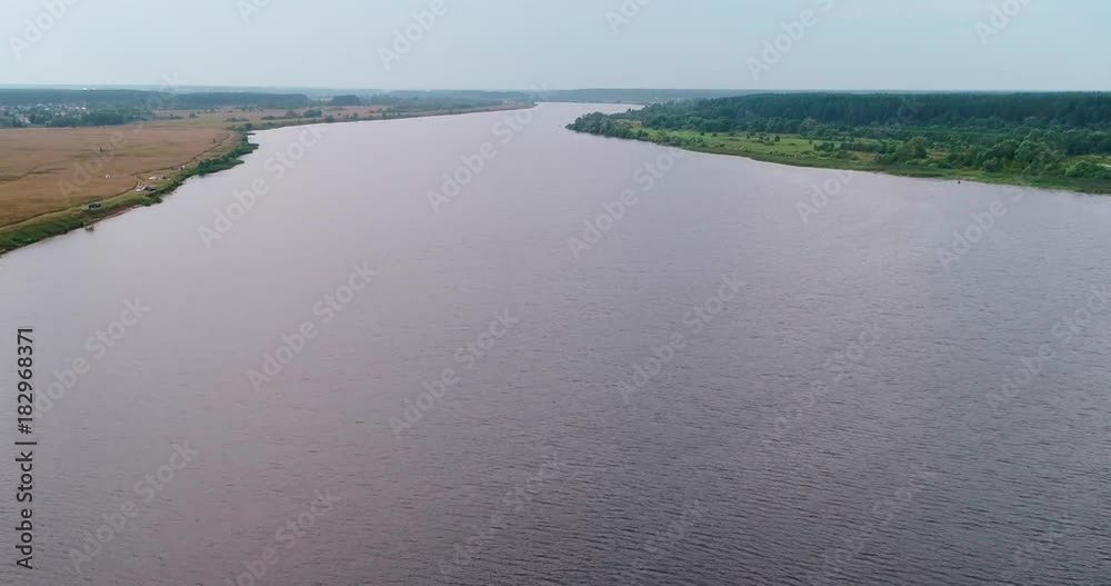 Volga river aerial view from flying quadcopter over forest. Landscape panorama. Beautiful nature. Horizon in the background of fields of meadows and sky. Volga river aerial view from flying quadcopter over forest. Landscape panorama. Beautiful nature. Horizon in the background of fields of meadows and sky.