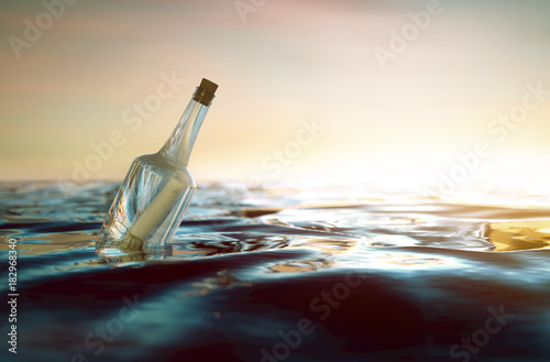 Flaschenpost treibt im Meer photo