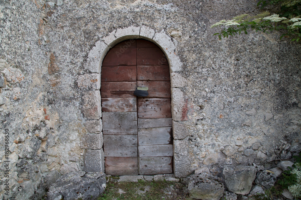 Entrance of an antique stone house in Italy 