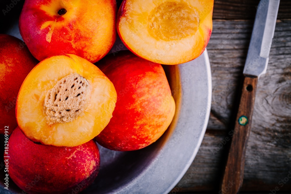 Fresh raw organic peaches on wooden background.  Closeup