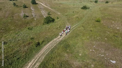 Aerial view: Cap tourists hiking mountain trail tourist mountains beautiful landscape autentic view couple trekking walking backpacks trail tourism Crimea Russia aero motion photo