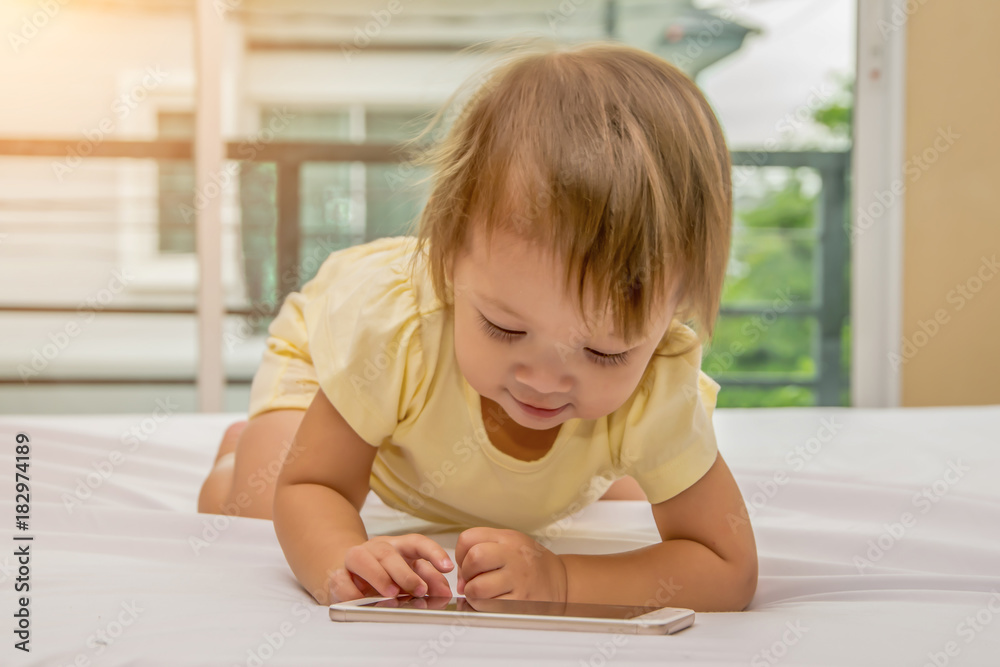 Baby kid using smartphone. Isolated on white background Baby kid using smartphone. Isolated on white background