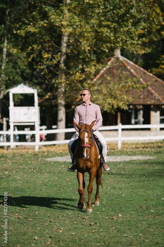 Elegant casually dressed man with horse.