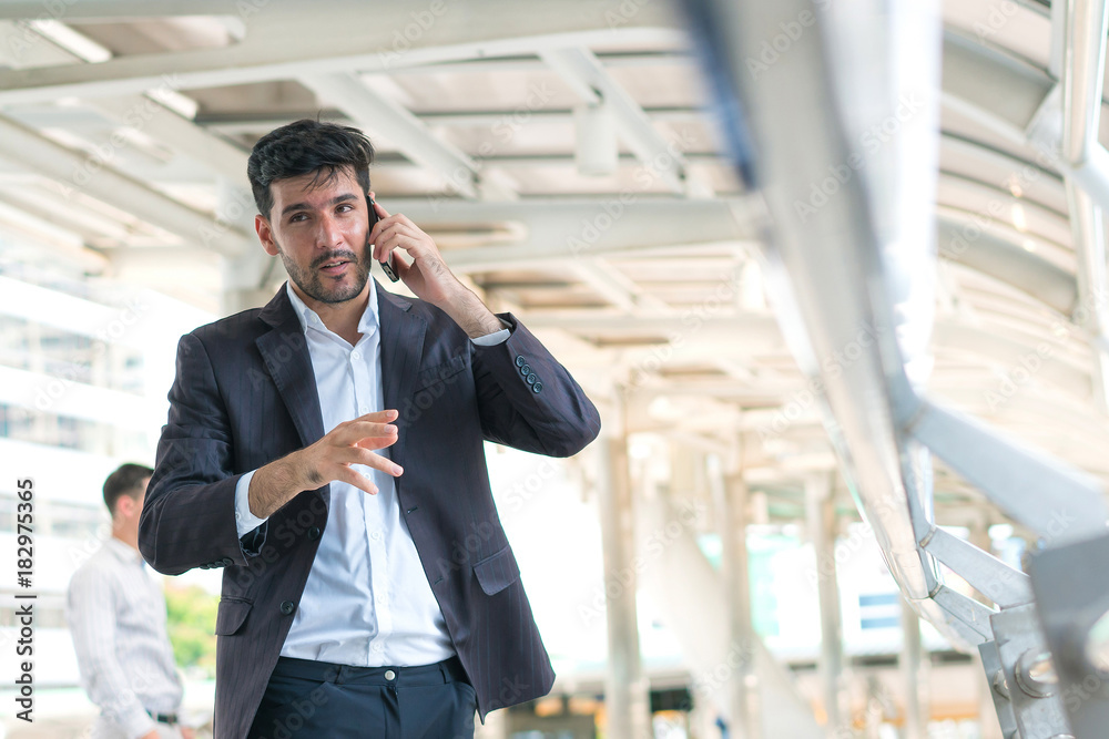 Business man talking smartphone at outdoors. Concept of business professional and consult. Business man talking smartphone at outdoors. Concept of business professional and consult.