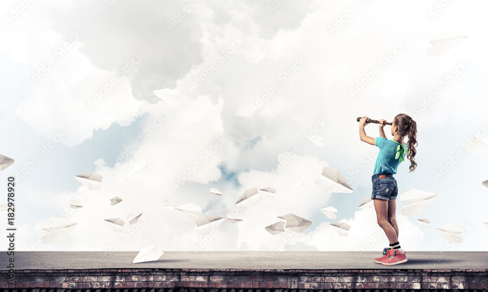 Concept of careless happy childhood with girl exploring this wor Concept of careless happy childhood with girl exploring this wor