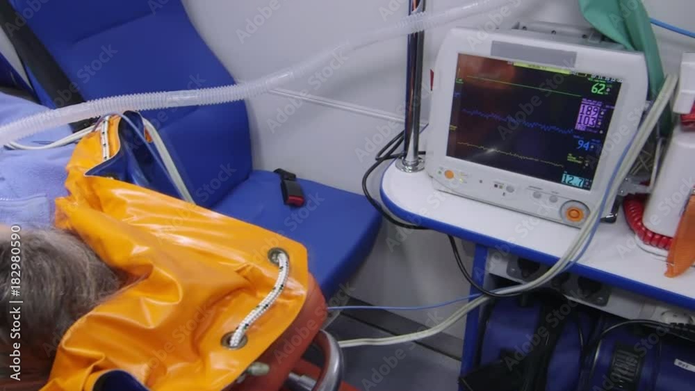 Emergency medical service. Ambulance car interior. Paramedic provides critical care to the patient during transport. Transfer of critically ill patient. Shaky handheld camera. Emergency medical service. Ambulance car interior. Paramedic provides critical care to the patient during transport. Transfer of critically ill patient. Shaky handheld camera.