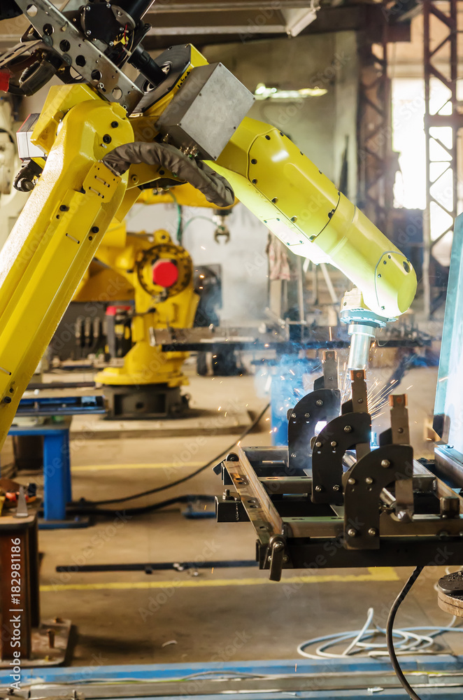 Fototapeta premium Welding robot in operation / Photo taken in Russia, in factory premises