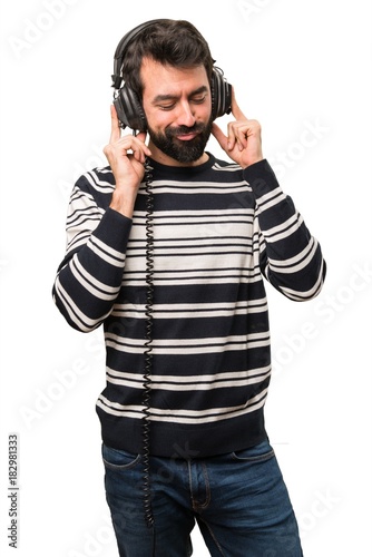 Man with beard listening music