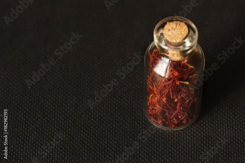 Dried saffron spice in black background photo