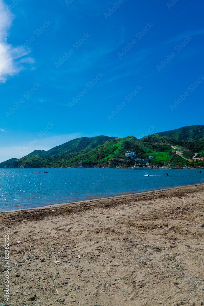 Beautiful outdoor view of Taganga, the caribbean coast with some tourists enjoying the sunny day in Colombia