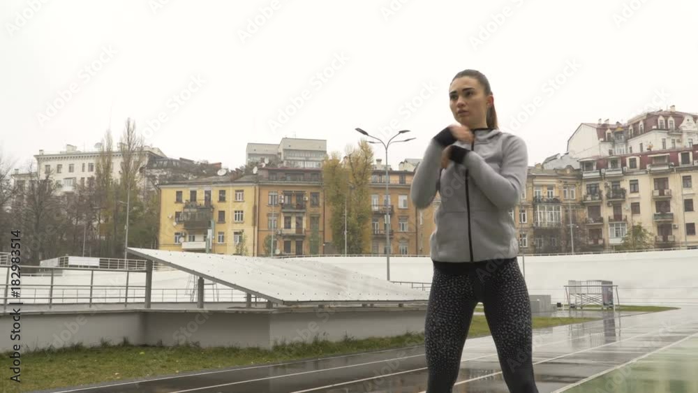 Young motivated woman runner warm up outdoor