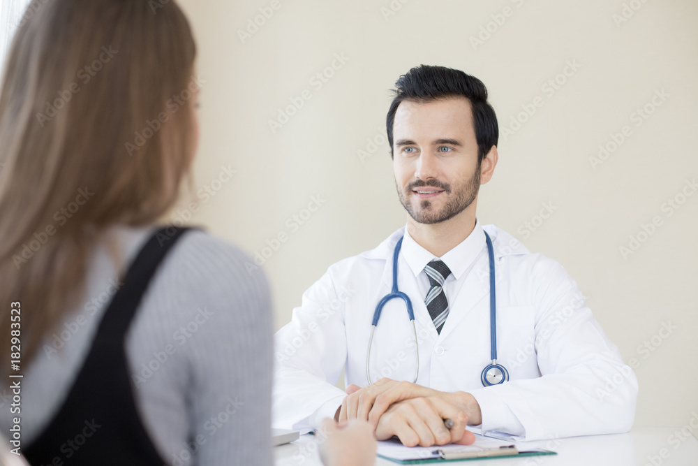 Attractive Doctor working at hospital. Doctor try to explan woman for any problem. Attractive Doctor working at hospital. Doctor try to explan woman for any problem.