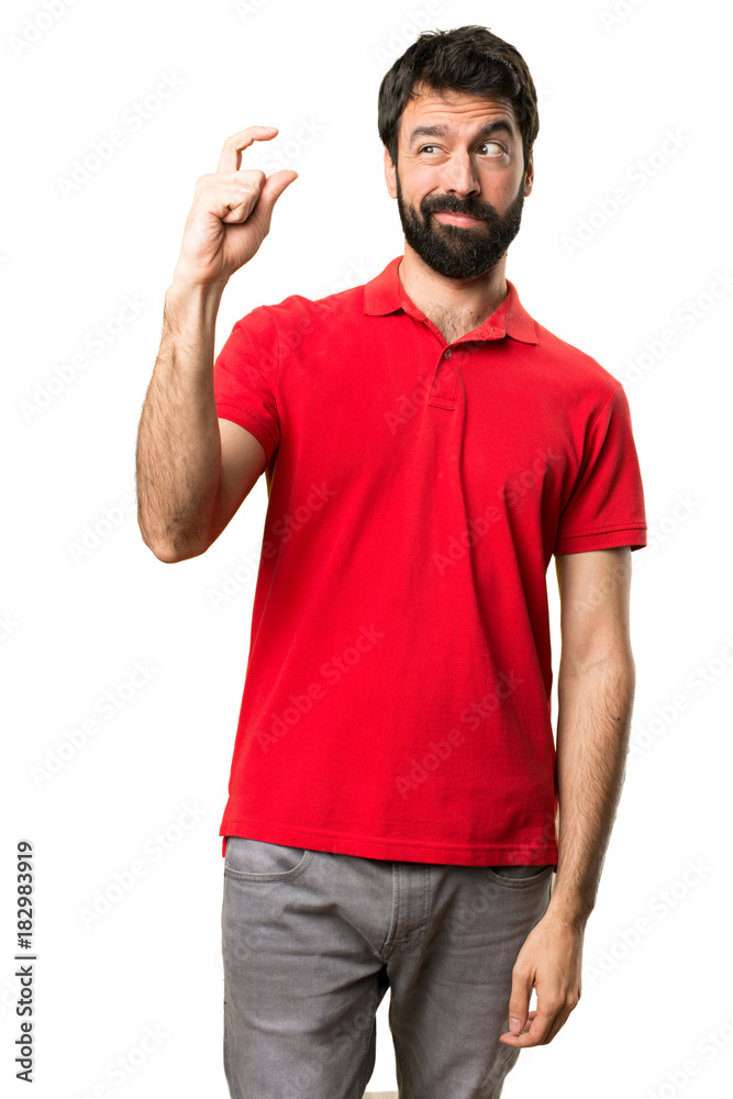 Handsome man making tiny sign Handsome man making tiny sign