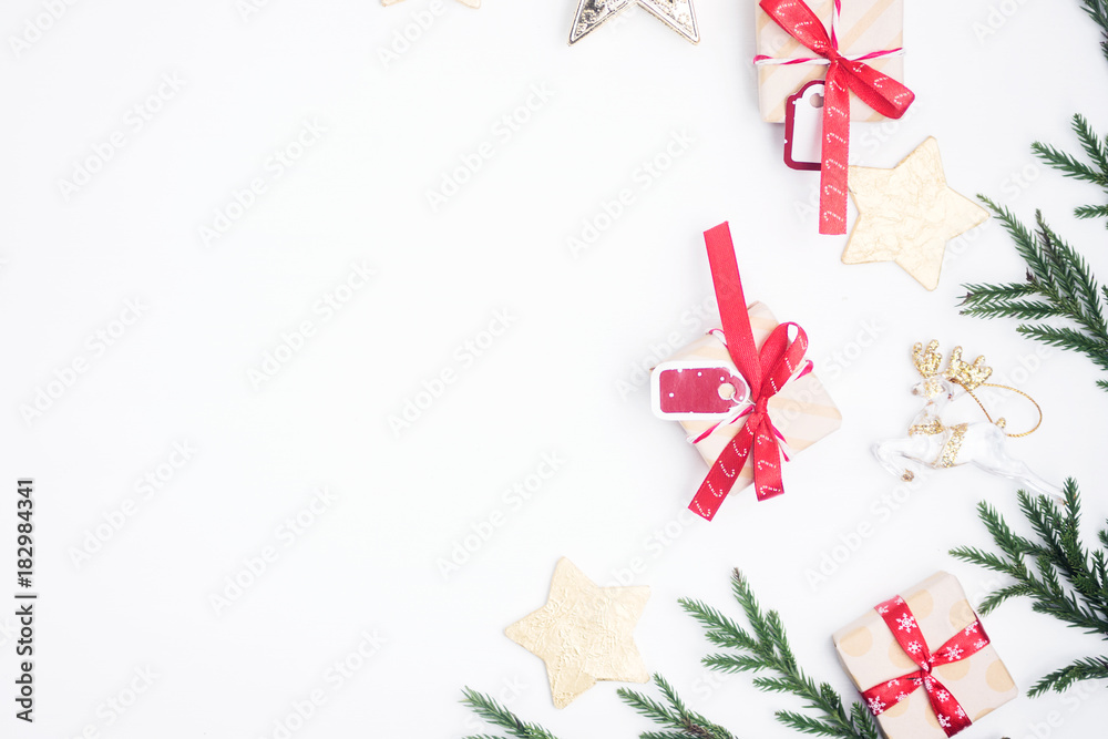 Flat lay, top view christmas composition. Christmas gift, pine cones, toys, fir branches on white background. New year concept Flat lay, top view christmas composition. Christmas gift, pine cones, toys, fir branches on white background. New year concept