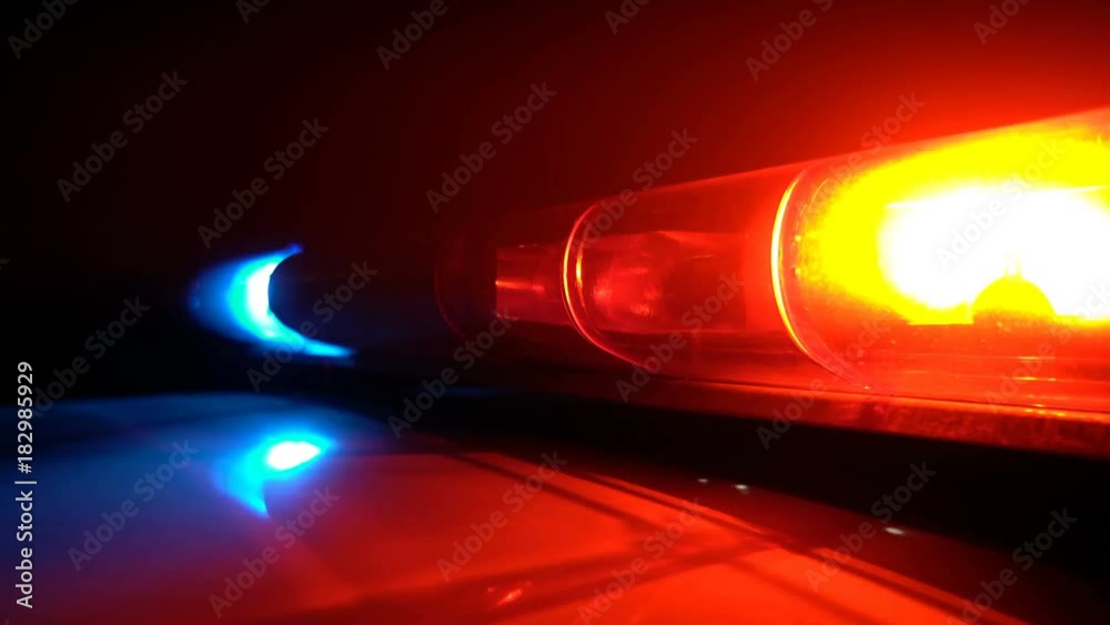 Police blue and red lamp flashing spinning in the dark
