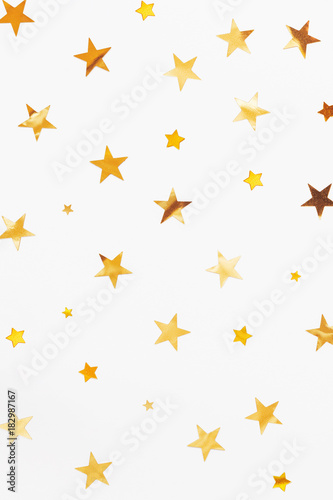 Holiday background with golden star confetti. Good background for Christmas and New Year cards.