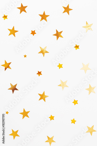Holiday background with golden star confetti. Good background for Christmas and New Year cards.