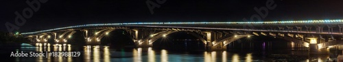 Night panorama of the Metro bridge across the Dnipro in Kyiv