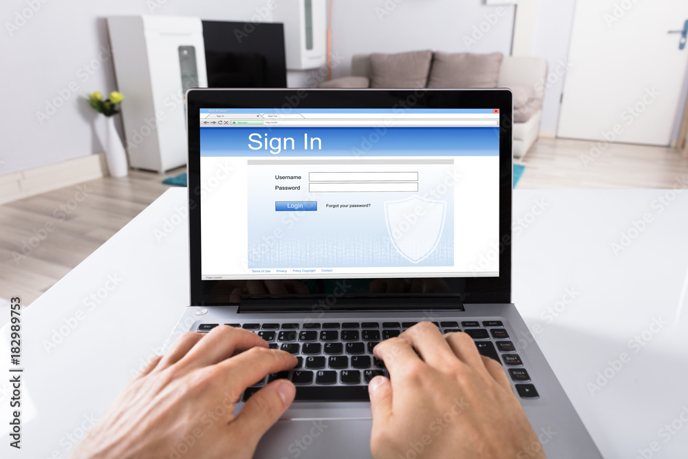 Person Signing Into Website On Laptop Person Signing Into Website On Laptop