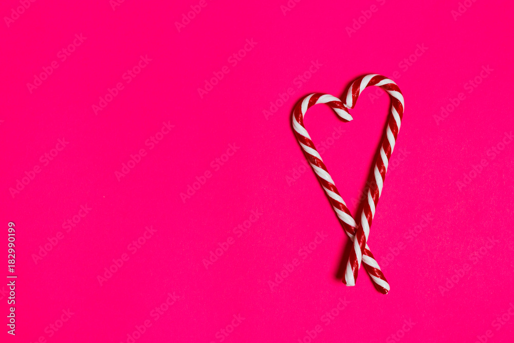 christmas candy heart on pink background. copy space
